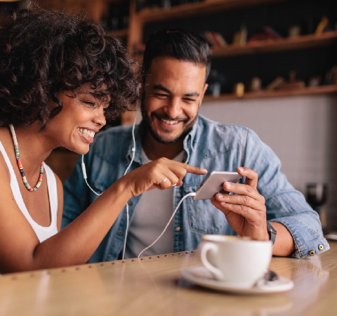Two people watching content on a smartphone.
